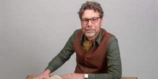 Collectiespecialist Huib met een krant