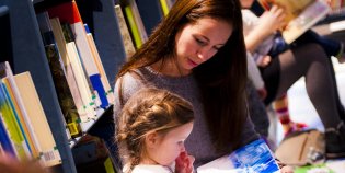 Volwassenen lezen kinderen voor in de bibliotheek