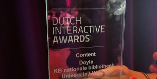 Een foto van een Dutch Interactive Award, een glasplaat met tekst op een voet.