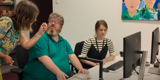 Overleg bij pc tussen 3 mensen