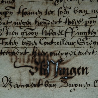 Handgeschreven tekst. Het papier is aangetast door inktvraat, er zitten gaten in en de inkt is uitgelopen.